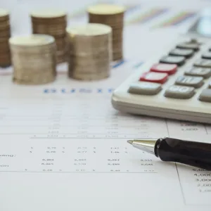 Company Director Reviewing Financial Statements At A Desk — Cohen Legal Townsville